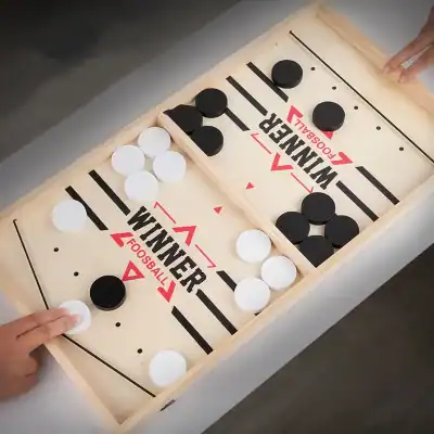 Hockey table game with black and white caps, perfect for family fun and recreational activities. Durable wooden frame with clear markings, suitable for all ages.