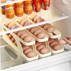 High-quality eggs organized in trays inside a refrigerator, with several cartons stacked neatly, showcasing freshness and cleanliness ideal for quick access.