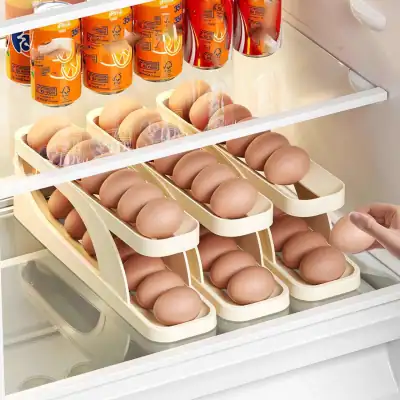 High-quality eggs organized in trays inside a refrigerator, with several cartons stacked neatly, showcasing freshness and cleanliness ideal for quick access.