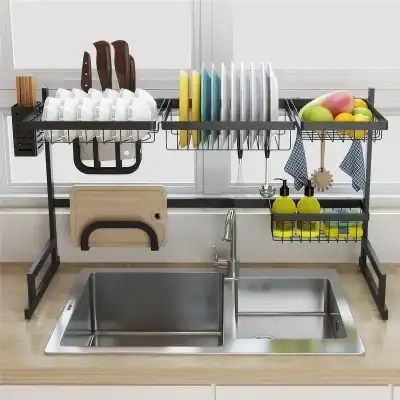 A stylish and functional black metal dish drying rack with sections for plates, utensils, fruits, and cleaning supplies, placed above a stainless steel sink for efficient drying and kitchen organization.