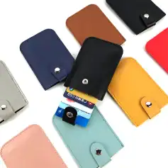 Colorful, compact leather cardholders perfect for organizing credit cards, IDs, and optical prescriptions. Available in black, blue, red, yellow, gray, pink, and brown.
