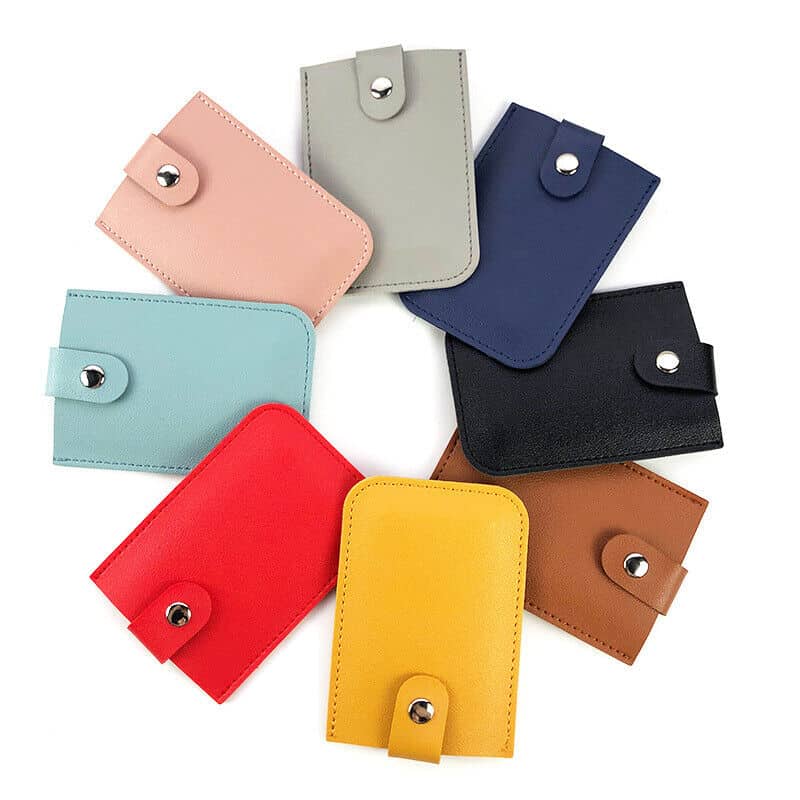 Vibrant collection of leather wallets including pink, gray, navy, black, light blue, red, yellow, and brown, perfect for stylish storage and everyday use.