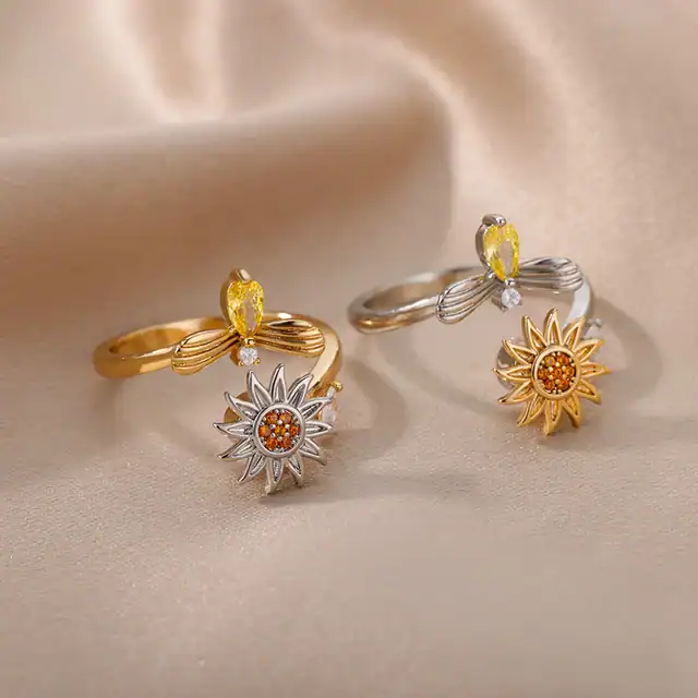 Beautiful sunflower-inspired rings with yellow gemstones and intricate silver and gold designs, perfect for stylish jewelry enthusiasts and gifting occasions.