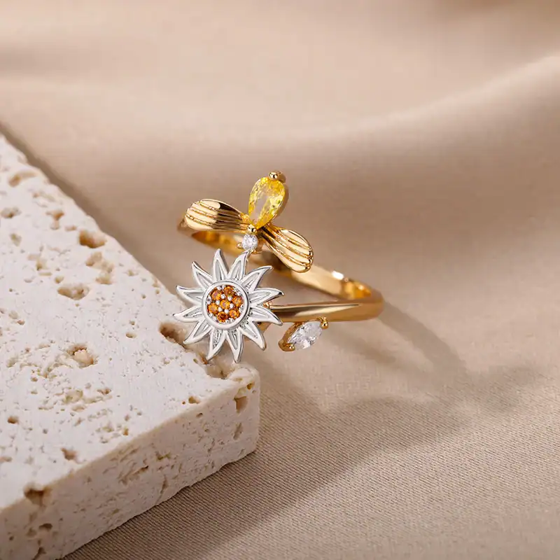 Delicate gold ring featuring floral design and gemstone accents, perfect for stylish accessories and gift options.