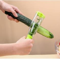 A person using a cucumber as a makeshift tool to clean or prepare sunglasses, showcasing a creative approach with fresh vegetables.