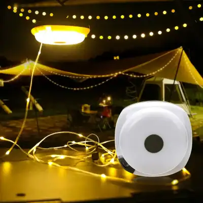 LED string lights illuminating outdoor camping area at night, creating a cozy and festive atmosphere with tents, string lights, and a camping setup.