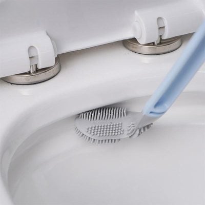 Close-up of a tooth cleaning brush with a toothbrush on a dental sink or basin, ideal for dental hygiene and oral care essentials.