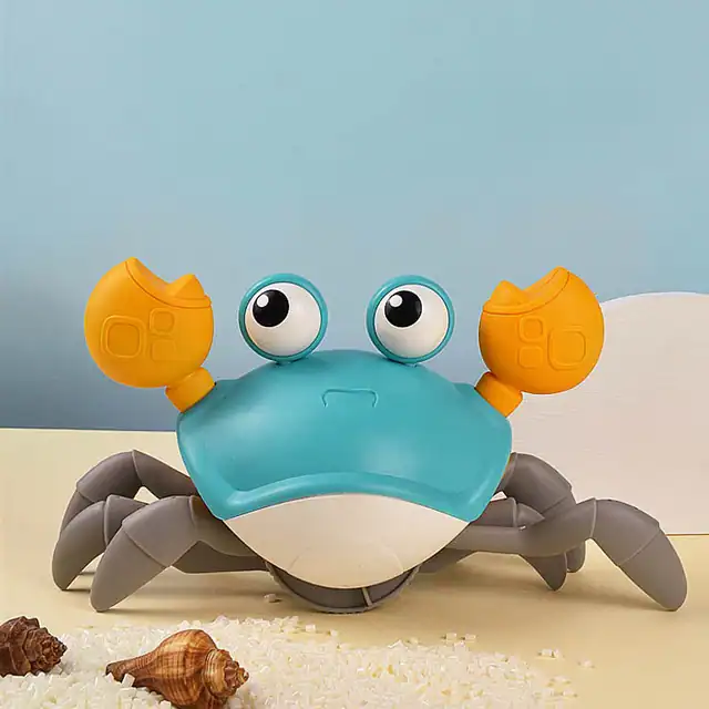 Playful crab-shaped robot toy with large googly eyes and orange claws, designed for children's entertainment and educational purposes.