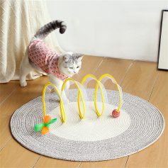 A playful cat interacts with a maze toy featuring bright yellow hoops and hanging toys, designed to stimulate curiosity and mental sharpness in indoor cats.