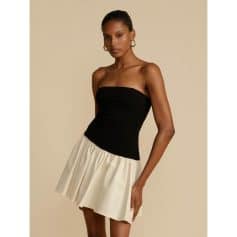 Sophisticated strapless dress with a black bodice and cream skirt, ideal for fashion-forward women seeking elegant styles. Perfect for parties, dinners, and special occasions.