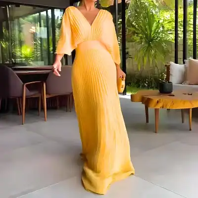 Stylish yellow maxi dress with pleated design, perfect for formal events or summer outings. Made from lightweight, flowing fabric for a comfortable, chic look.