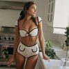 Beautiful young woman in stylish black and white lingerie, showcasing fashionable sleepwear for women, perfect for comfort and chic look, ideal for sleep, lounge or intimate wear.