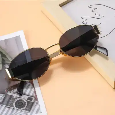 Stylish gold-framed sunglasses with black tinted lenses, perfect for sun protection and fashion accessories.