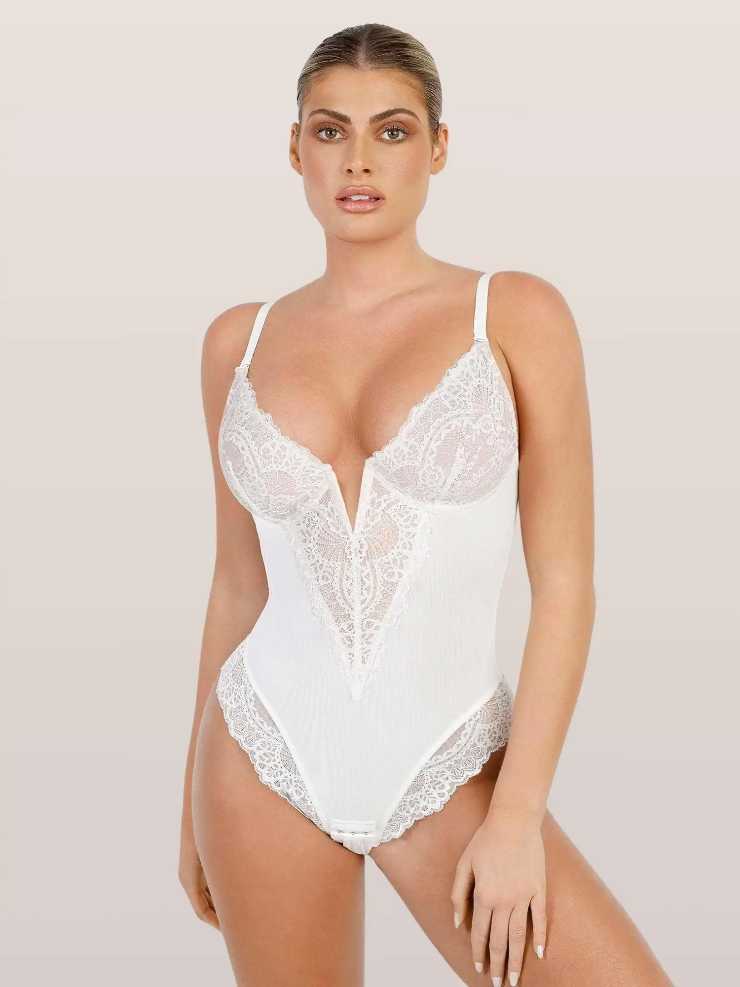 Modern white lace bodysuit with intricate details, perfect for fashion-forward women seeking stylish lingerie and intimate wear.