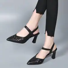 Stylish black high-heel shoes with cut-out design, perfect for women seeking fashionable footwear at Monalisa Medical Store, combining comfort with trendy style.