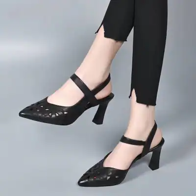 Stylish black high-heel shoes with cut-out design, perfect for women seeking fashionable footwear at Monalisa Medical Store, combining comfort with trendy style.