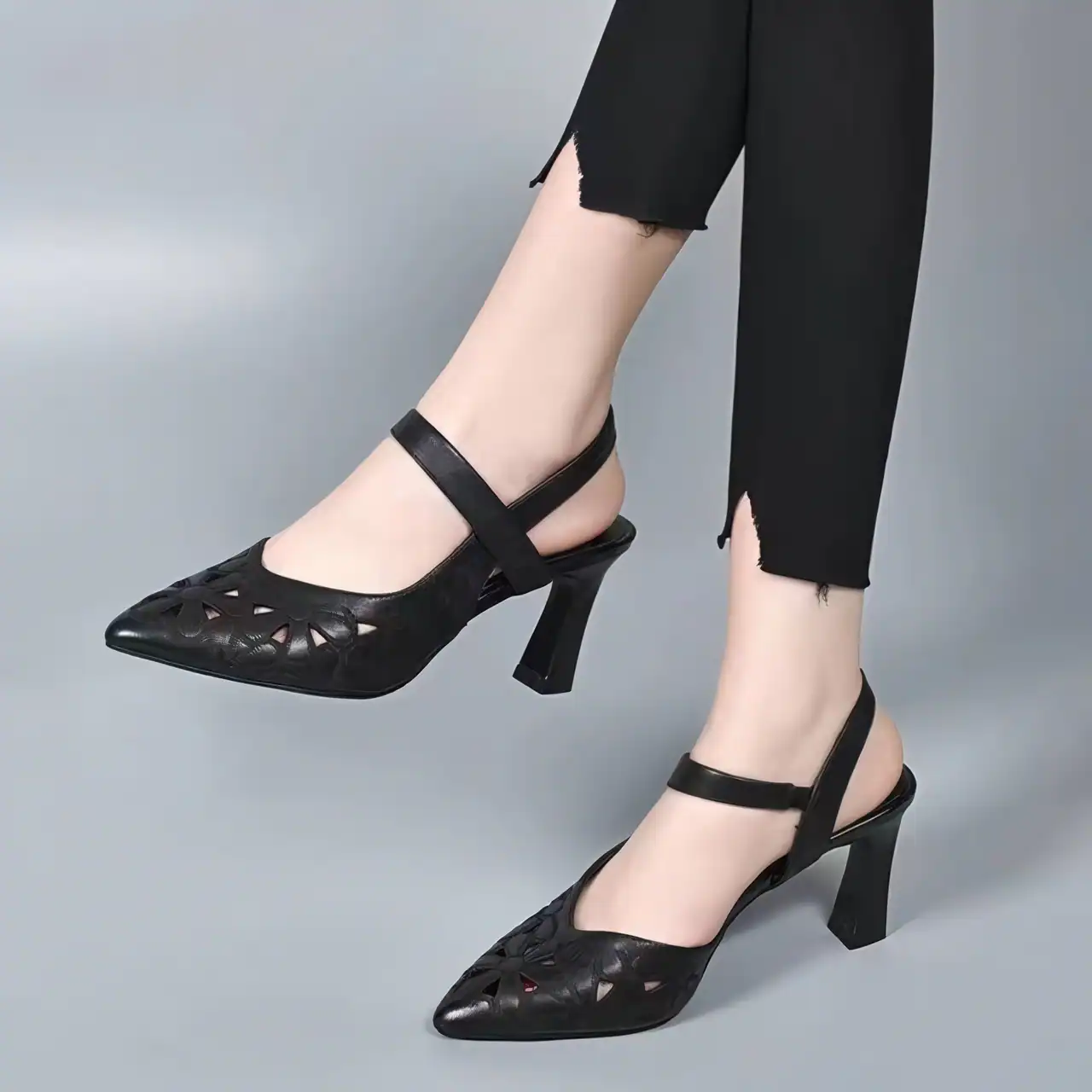 Stylish black high-heel shoes with cut-out design, perfect for women seeking fashionable footwear at Monalisa Medical Store, combining comfort with trendy style.
