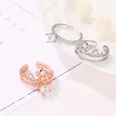 Close-up of sparkling diamond rings in rose gold and silver, featuring intricate designs and high-quality gemstones, displayed on a white surface for jewelry lovers and gift shoppers.