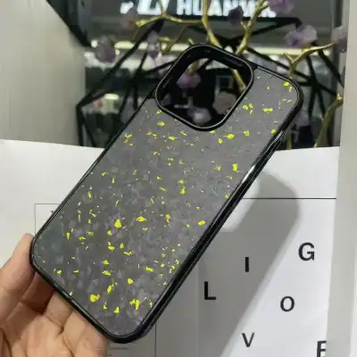 Stylish black phone case with yellow sparkle accents, compatible with iPhone models, ideal for fashion-forward consumers seeking eye-catching mobile accessories.