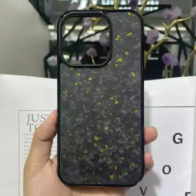 Dark black phone case with gold flecks, perfect for iPhone 13 Pro, offering premium protection and a sleek design.