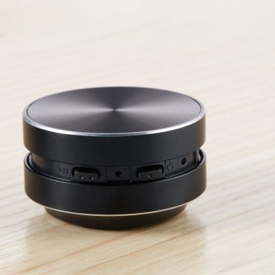 Compact black wireless Bluetooth speaker with control buttons, ideal for premium audio and convenience in mobile and home use.