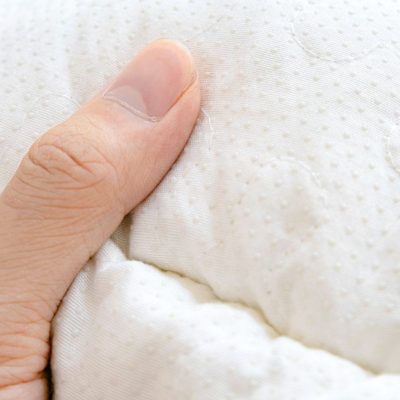 Close-up of a hand holding a clean, stylish white eyeglasses case showing textured fabric and details. Perfect for storing and protecting your favorite glasses from Monalisa Store’s premium selection.