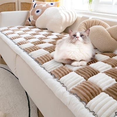 Soft, plush pet bed with warm, textured blankets and cushions, perfect for cats to relax comfortably at home. Stylish, inviting, and designed for feline comfort.