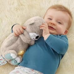 Adorable baby hugging a soft plush teddy bear, lying on a cozy cream-colored rug, showcasing comfort and happiness, perfect for children's comfort and play.