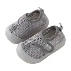 Gray mesh barefoot shoes for babies, lightweight and breathable with soft soles, perfect for early walking. Features easy slip-on design and comfortable fit for infants.