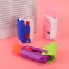 Brightly colored handheld staplers in pink, blue, purple, and green, perfect for office, home, or school. Durable design for secure staples, easy to use, and portable.