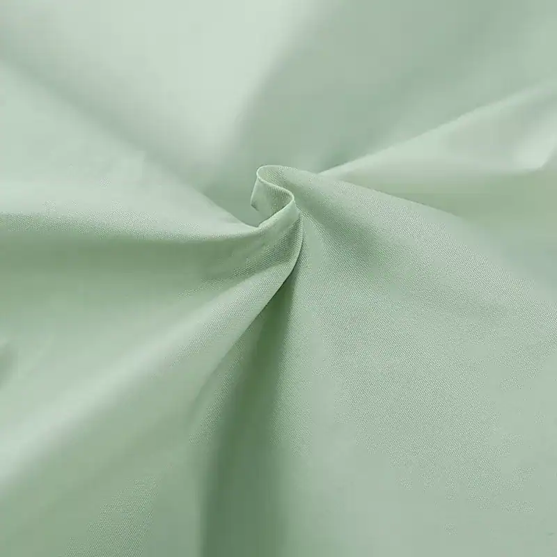 Soft pastel green fabric for medical use, fabric swatch for surgical, hospital, or optometry environments, lightweight, breathable, and durable material.