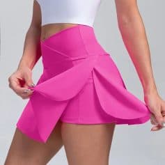 Pink athletic skirt for women, stylish and comfortable, perfect for sports and casual wear. Unique design with layered fabric, ideal for active lifestyles and fashion-forward outfits.