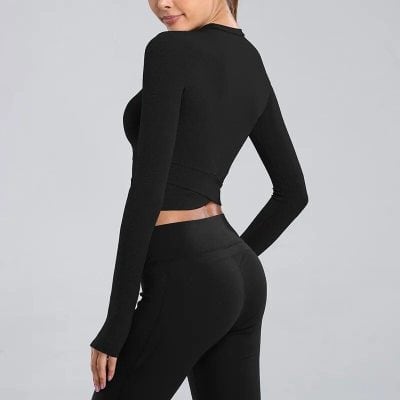 Women's black long sleeve fitness top ideal for workouts and activewear.