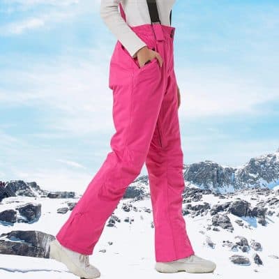 Bright pink winter ski pants for women, insulated and waterproof for snow activities. Stylish and warm outdoor apparel for skiing and snowboarding adventures.