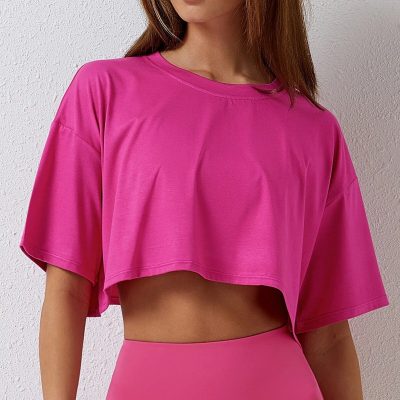 Stylish pink cropped yoga shirt made from breathable, lightweight fabric perfect for activewear and fitness routines. Comfortable fit ideal for women seeking trendy workout clothing.