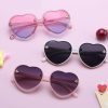 Stylish heart-shaped sunglasses with pink, black, and purple tinted lenses, perfect for girls who love trendy eyewear and eye protection from UV rays.