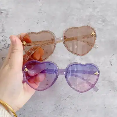 Colorful heart sunglasses with glitter frames, ideal for fashion-forward individuals seeking stylish eye protection, featuring pink and purple lenses with trendy design.