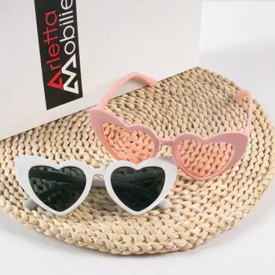 Colorful children’s heart-shaped sunglasses with UV protection, perfect for kids' sunny days, boating, or outdoor activities, featuring pink and white frames with dark lenses.