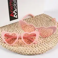 Pink heart-shaped sunglasses with wide lenses, fashionable women's eyewear offering UV protection, ideal for summer outings, beach days, and stylish accessories.