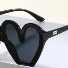 Stylish black heart-shaped sunglasses with UV protection, perfect for women and men. Trendy eyewear accessory for outdoor, parties, or daily fashion.