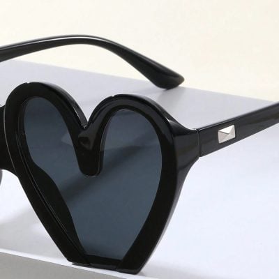 Stylish black heart-shaped sunglasses with UV protection, perfect for women and men. Trendy eyewear accessory for outdoor, parties, or daily fashion.