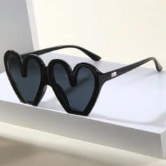 Stylish heart-shaped black sunglasses with dark tinted lenses, perfect for fashion-forward eyewear lovers seeking bold, trendy accessories for sunny days.