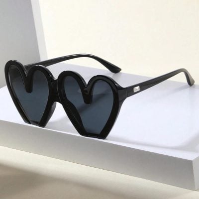 Stylish heart-shaped black sunglasses with dark tinted lenses, perfect for fashion-forward eyewear lovers seeking bold, trendy accessories for sunny days.