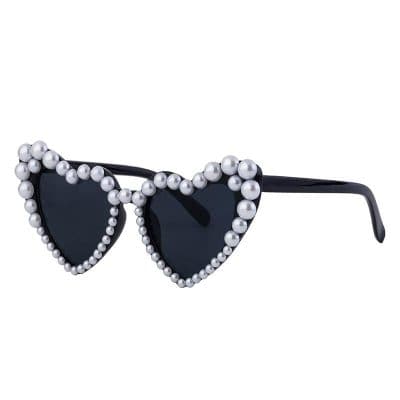 Stylish black heart-shaped sunglasses adorned with pearls for trendy eyewear fashion. Perfect for chic, modern look and eye protection.