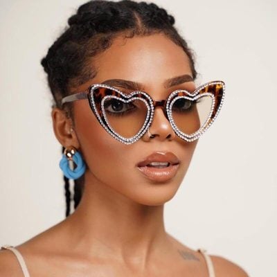 Stylish heart-shaped sunglasses with rhinestone detailing, perfect for trendy optical accessories.