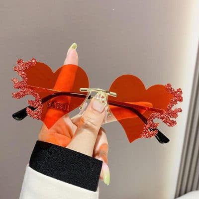 Stylish heart-shaped sunglasses with red glitter accents, perfect for fashion accessories at Monalisa Medical store. Ideal for enhancing your look and making a statement.