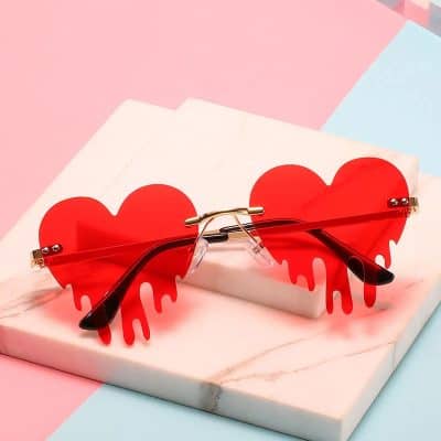 Red heart-shaped sunglasses with a dripping design, perfect for stylish sunglasses lovers and fashion enthusiasts.