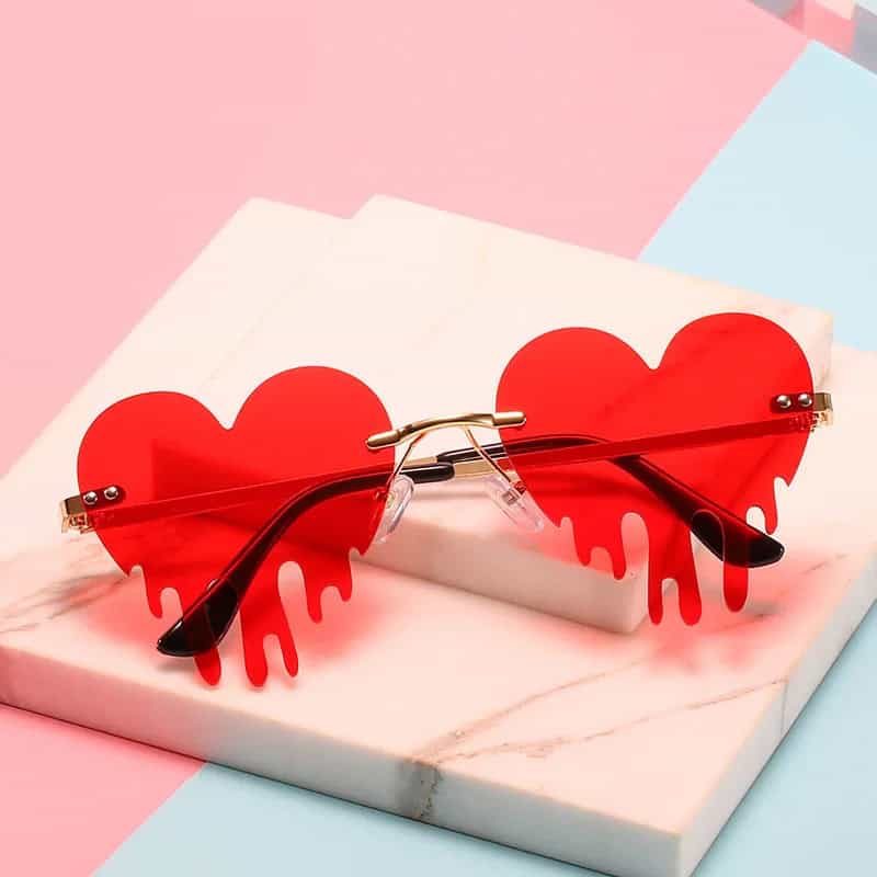 Red heart-shaped sunglasses with a dripping design, perfect for stylish sunglasses lovers and fashion enthusiasts.