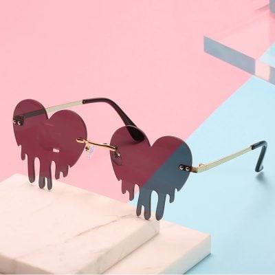 Stylish heart-shaped sunglasses with unique dripping design, perfect for fashion-forward individuals seeking trendy eyewear and UV protection.