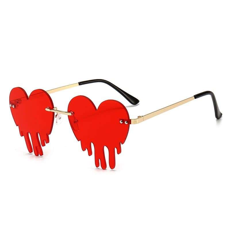 Stylish red heart-shaped sunglasses with dripping design, ideal for fashion-forward eyewear lovers and opticians.